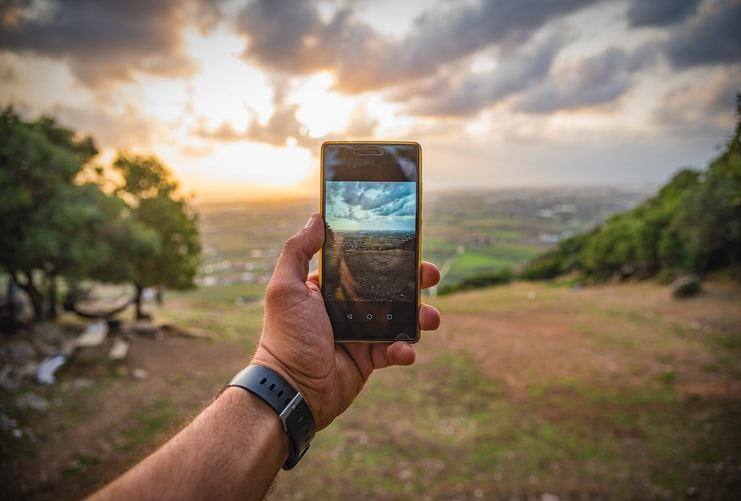 cloud computing - image of clouds on a mobile phones screen