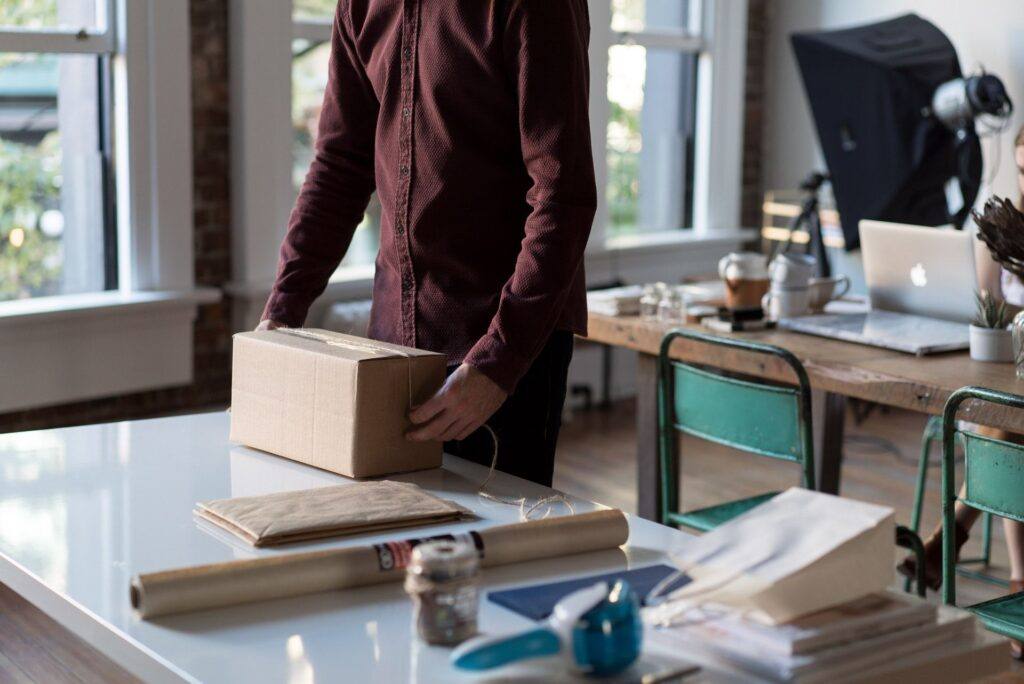 successful it relocation, man boxing up something in office